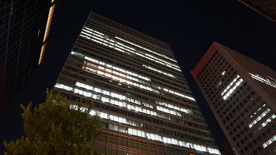 Night view of a high-rise condominium along an urban river