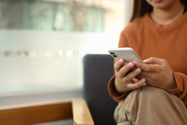 istock Relaxed young woman texting messages and enjoy chatting in social on smartphone during work break 2009736167