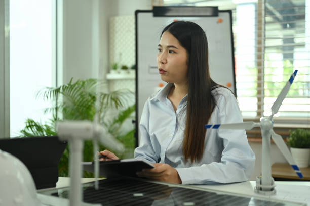 istock Businesswoman working on new alternative energy development with team in office 2009737759