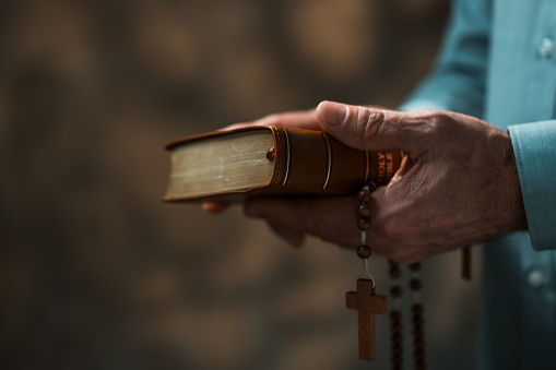 Senior man holding Holy Bible
