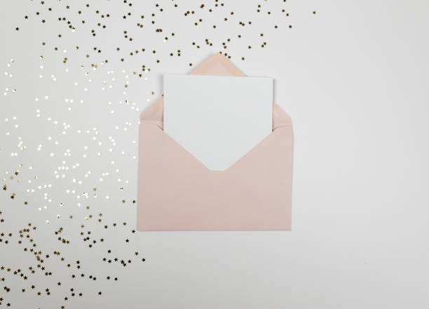 istock Christmas composition, pink envelope, gold stars confetti on white background. Christmas, New Year, winter concept. 2009744698