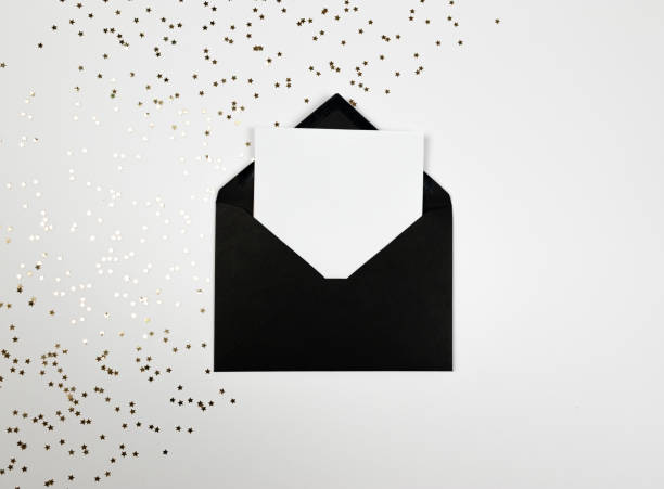 istock Christmas composition, black envelope, gold stars confetti on white background. 2009744700