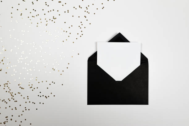 istock Christmas composition, black envelope, gold stars confetti on white background. 2009744711