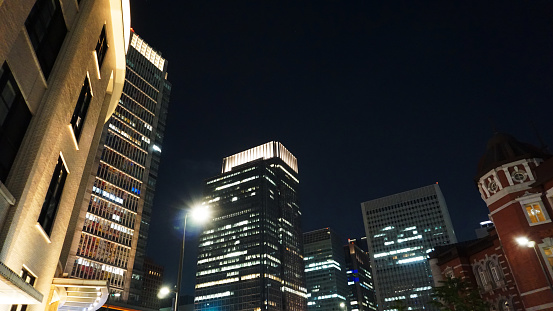 Night view of a high-rise condominium along an urban river