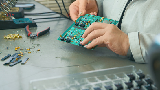 Circuit board at the final stage in the hands of a specialist