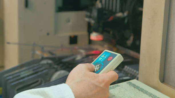 istock Close-up of a control panel in the hand of a factory worker 2009763348