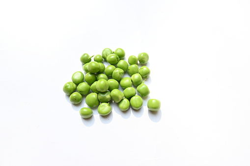 Fresh green pea isolated on white background. There is a lot of vitamins  and Minerals in it. The pea is most commonly the small spherical seed or the seed. Popular vegetable of all over world.