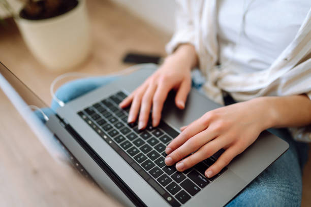 istock Close-up of hands working on a laptop keyboard. 2009814819