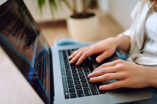 istock Close-up of hands working on a laptop keyboard. 2009814825
