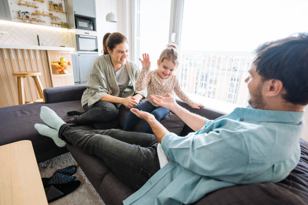 istock Parents playing with four year old daughter at home red hands. 2009818591