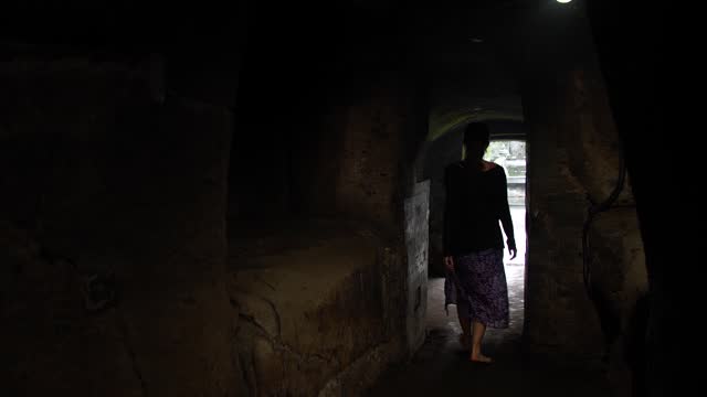 Woman coming out of a cave