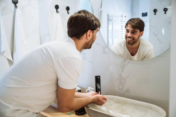 istock Young bearded man washing face in bathroom 2009820840