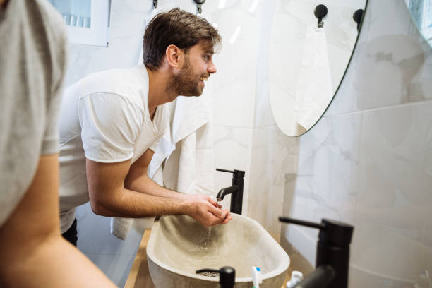 istock Young bearded man washing face in bathroom 2009821408