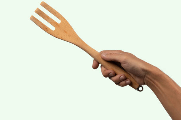 istock Hand holding wooden fork no background cutout 2009825231