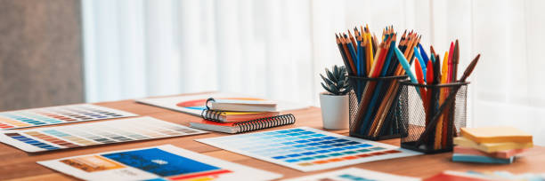 istock Various color palette idea papers arranged on workspace for designer. Scrutinize 2009834001