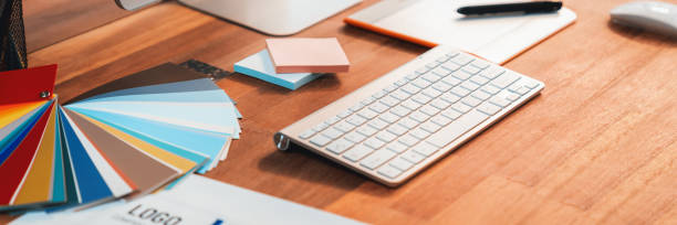 istock Graphic designer's workspace features color palette and laptop. Scrutinize 2009839498