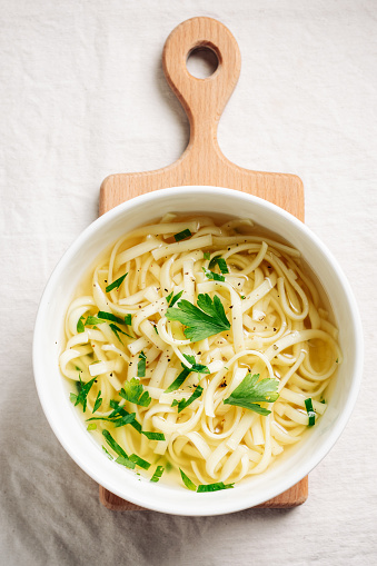 Noodles with chicken broth, pepper and parsley.