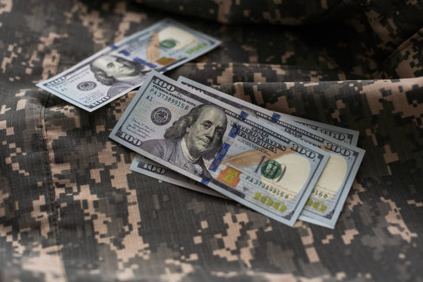 istock soldier camouflage, military uniform, money. 2009867752