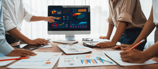istock Analyst team utilizing BI Fintech to analyze financial report. Scrutinize 2009868352