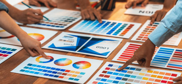 istock Graphic designer brainstorming logo and graphic arts at workshop. Scrutinize 2009874784