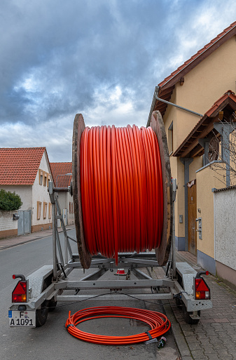frankfurt am main, germany-february 12, 2024: fiber optic cable reel on a roadside trailer