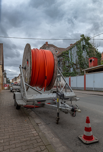 frankfurt am main, germany-february 12, 2024: fiber optic cable reel on a roadside trailer