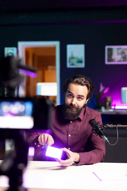 istock Video editor showing filming equipment to subscribers, recording with specialized devices 2009887404