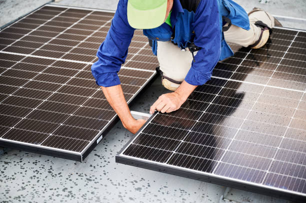 istock Workers building solar panel system on roof of house. Men installing photovoltaic solar module 2009888892