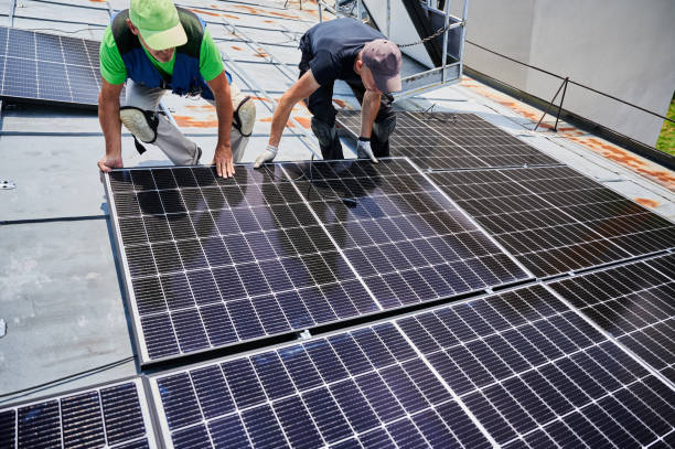 istock Workers building solar panel system on roof of house. Men installing photovoltaic solar module 2009889088