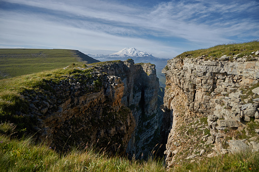 Landscape of Caucasus Bermamyt Canyon, stunning natural wonder awaiting adventurers. Mountains and rocky cliffs create a breathtaking panorama. Ancient geological formations and rugged beauty