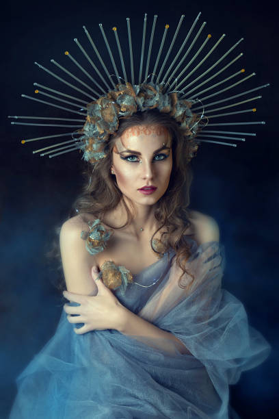 young beautiful woman wearing a creative crown. portrait of a gothic princess. magical image of the queen. decorative makeup. fantastic shot, fairy tale. brown-haired woman in a transparent blue dress - women crown princess 20s zdjęcia i obrazy z banku zdjęć