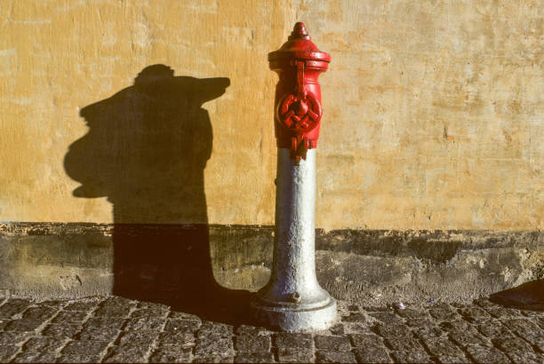 Red fire hydrant with red chain with blue sky background