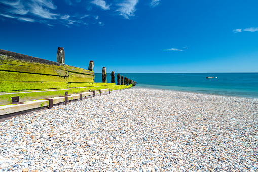 Shingle beach in hot weather in Selsey, West Sussex. Low, wide angle persepective
