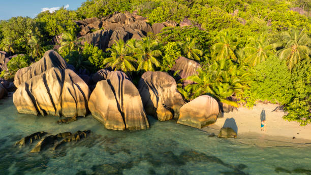 istock Anse Source d'Argent, La Digue Seychelles, young couple men and woman on a tropical beach 2009941668