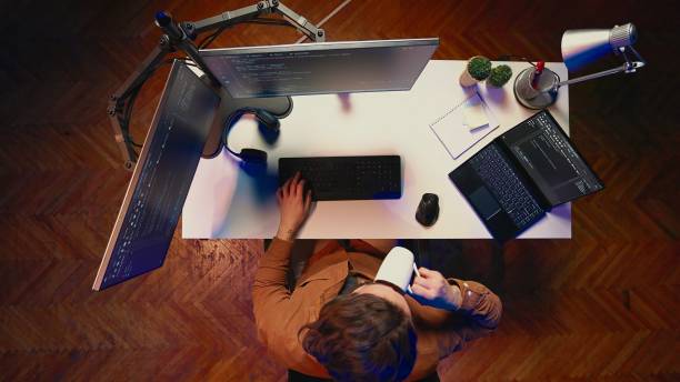 istock Top down view of self employed man doing IT support job, drinking coffee 2009943776