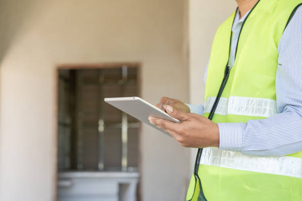 istock inspector or engineer is inspecting construction and quality assurance new house using a tablet. Engineers or architects or contactor work to build the house before handing it over to the homeowner 2009944326