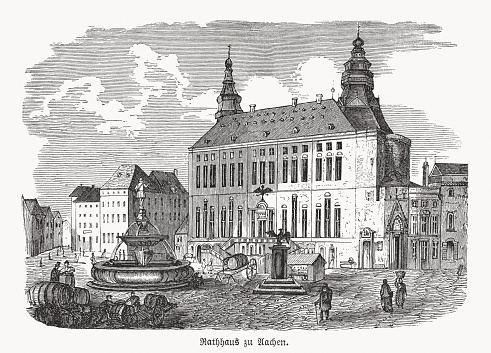 Historical view of Aachen Town Hall (German: Aachener Rathaus) - a landmark of cultural significance located in the Altstadt of Aachen, North Rhine-Westphalia, Germany. It was built in the Gothic style in the first half of the 14th century. Wood engraving, published in 1869.