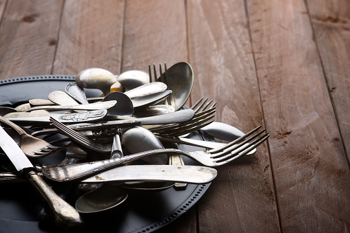 Metal cutlery on a wooden table