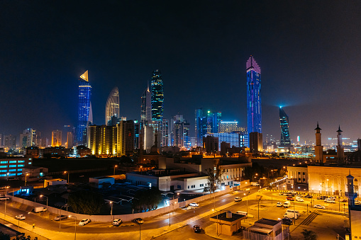Panoramic view of Kuwait City skyline at night.
