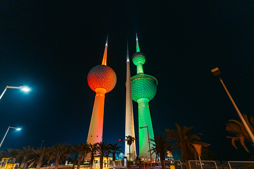 View of the illuminated Kuwait Towers at night.