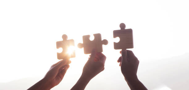 istock jigsaw puzzle. Charity, volunteering, business solutions, success and strategic ideas. Unity in business as a team 2010000727