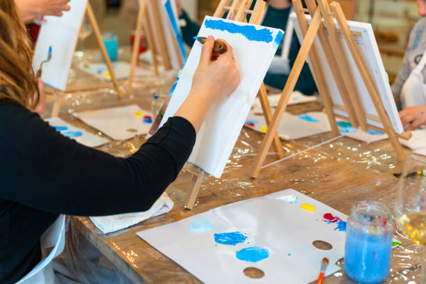 istock Sip and Paint Event. Painting classes paired with wine begin. 2010006137