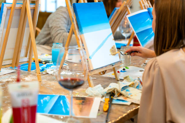 istock Sip and Paint Event. Students painting in art class. 2010006678