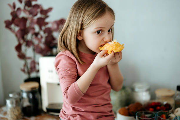 istock Beautiful girl tasting an orange 2010030488