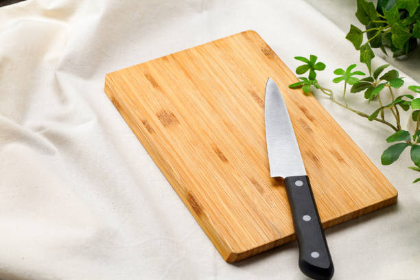istock Kitchen knife and cutting board on wooden table 2010051327