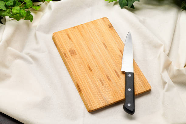 istock Kitchen knife and cutting board on wooden table 2010051566