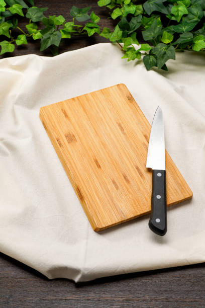 istock Kitchen knife and cutting board on wooden table 2010051863