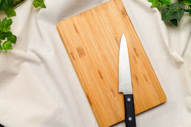 istock Kitchen knife and cutting board on wooden table 2010051871
