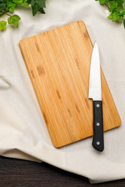 istock Kitchen knife and cutting board on wooden table 2010051885
