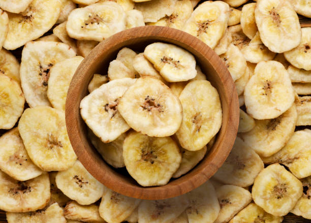 istock Dried bananas in a wooden plate, background. Top view 2010069346
